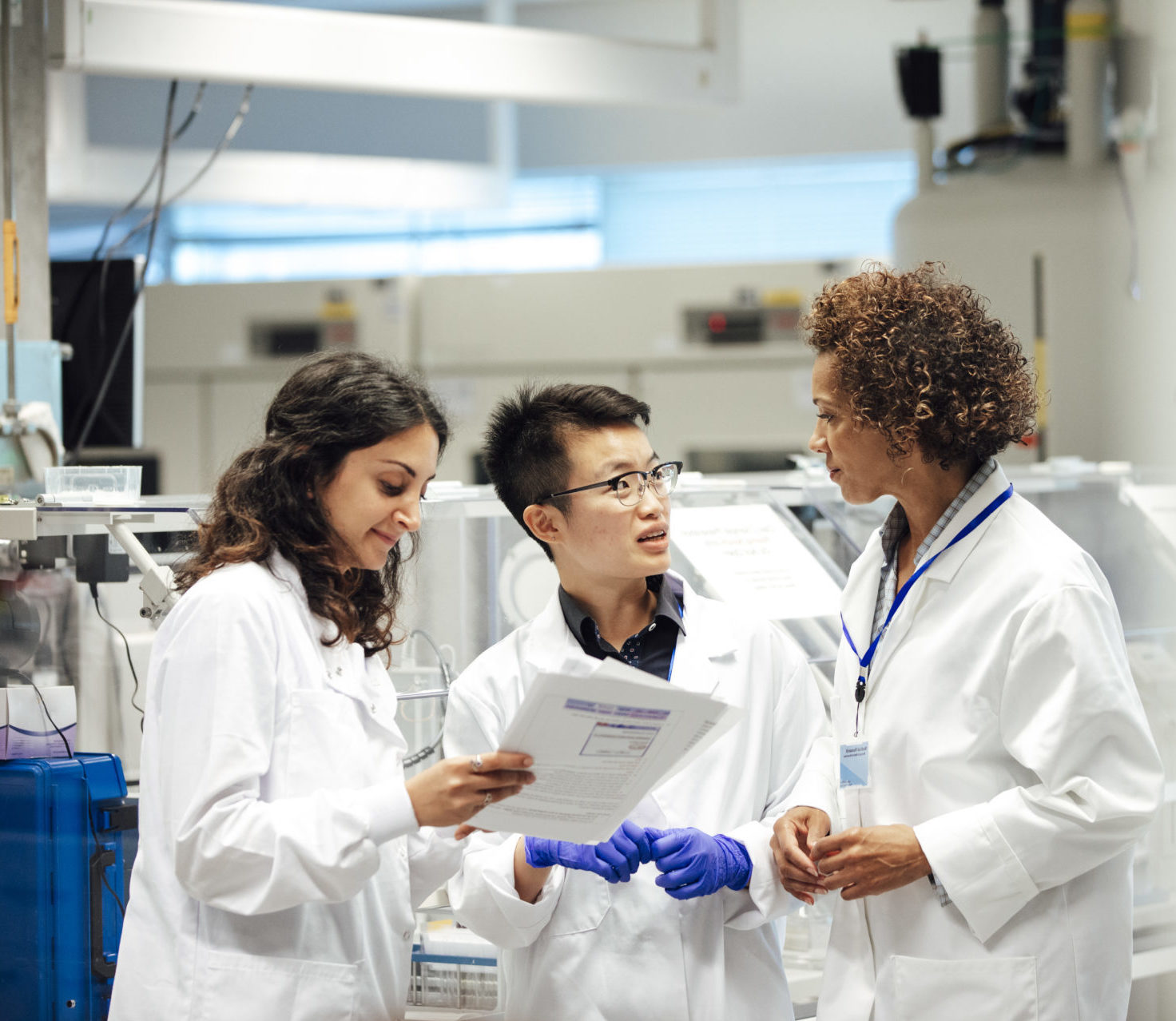 technicians wearing lab coats having a conversation
